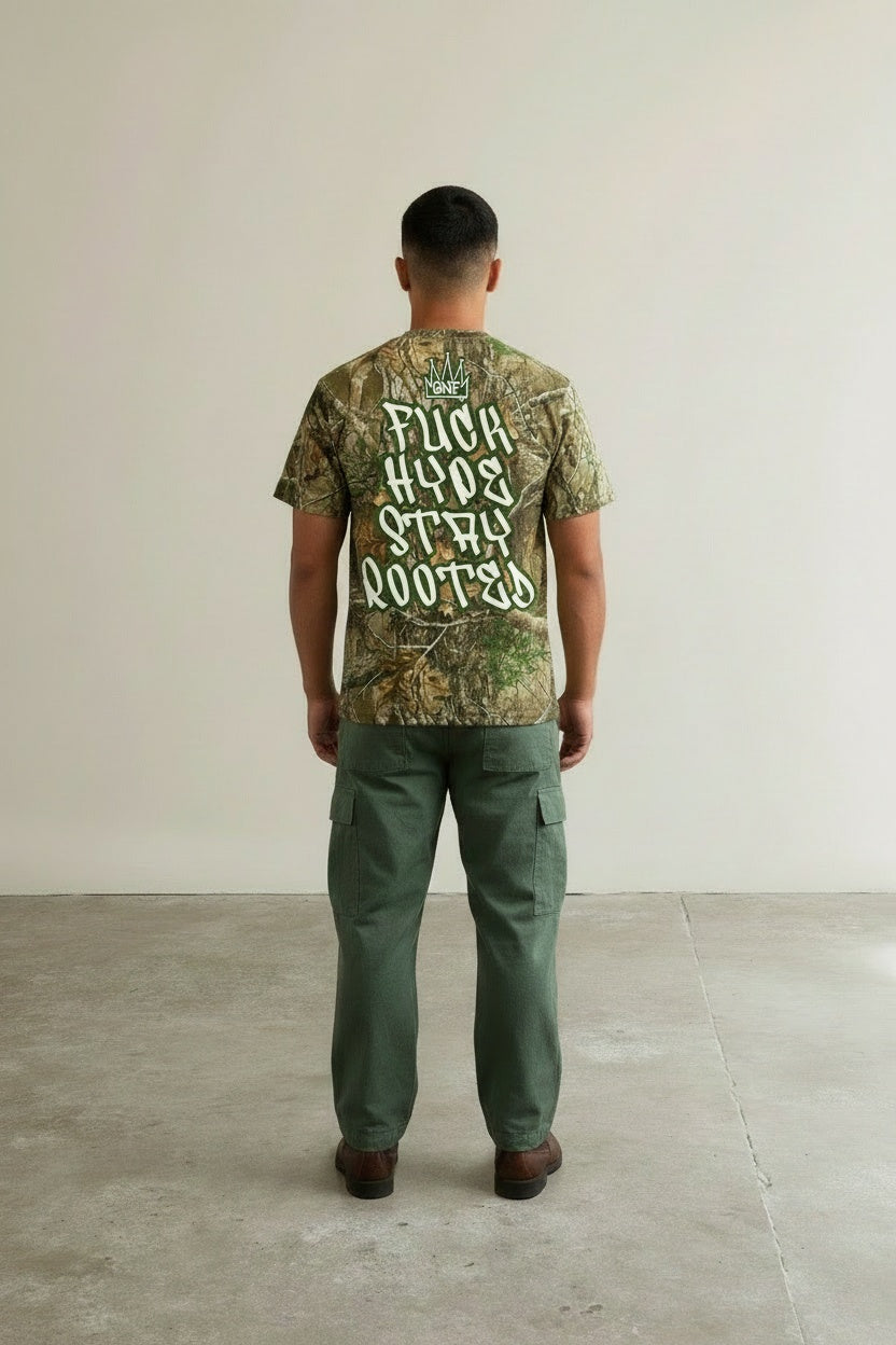 Back pose of the model wearing GNF Street - "Roots > Hype" Camo Tee
