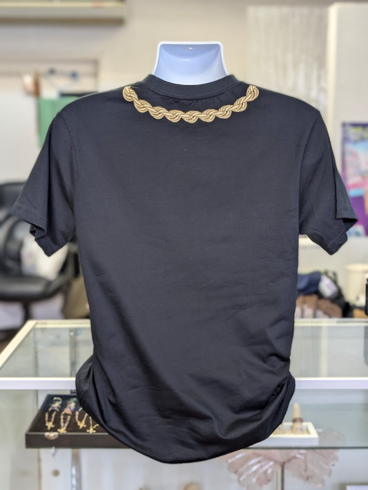 Black t-shirt with gold chain collar on a mannequin in a store setting