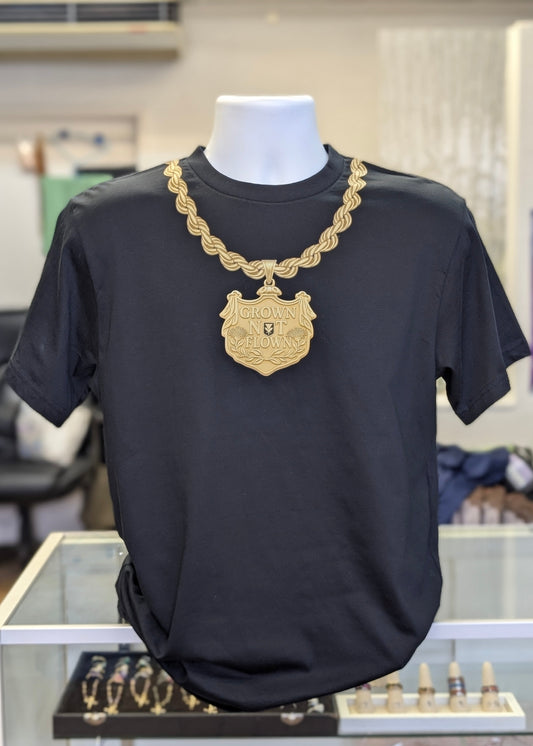 Black shirt with rope chain and hawaiian heirloom pendant design with ohia lehua blossoms and "Grown Not Flown".